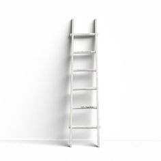 a white ladder leaning against a wall