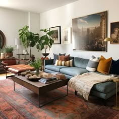 a living room filled with furniture and pictures on the wall