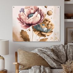 a living room scene with focus on the couch and large flower painting hanging above it