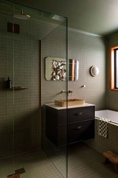 a bath room with a sink and a bath tub next to a window on the wall