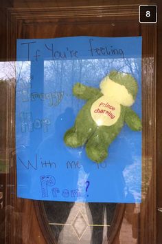 a teddy bear with a message attached to it's back is displayed in a window