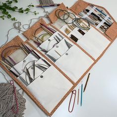 an assortment of crafting supplies laid out on top of a white table with scissors and yarn