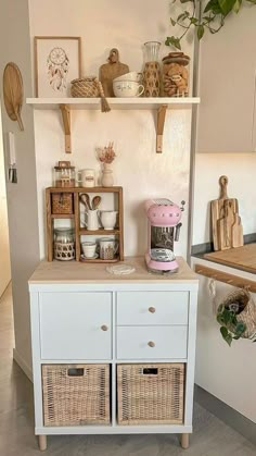 a kitchen with shelves and baskets on top of the cupboards in front of it