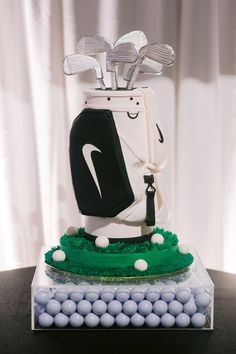 a cake made to look like a golf bag on top of a table with balls