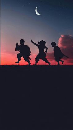 three people are silhouetted against the night sky with their arms in the air as they run