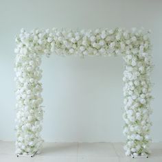 a large white flowered arch on the floor