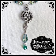 Coiled Snake Pendant In Silver With Iridescent Green Teardrop Stone Dangle From Snake Head At The Bottom. Choker Necklace In Various Green Beads With Silver Accents. Handmade Piece. One Of A Kind. Silver Teardrop Beaded Necklace, Silver Wire Wrapped Beaded Necklaces For Party, Silver Wire-wrapped Beaded Metal Necklace, Snake Pendant, Iridescent Green, Beaded Choker Necklace, Silver Accents, Beaded Choker, Green Bead