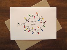 a white card with christmas lights on it and the words merry bright written in red