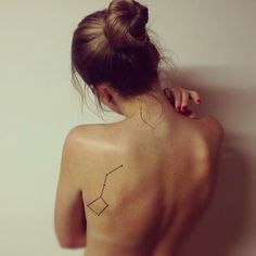 a woman with a tattoo on her back