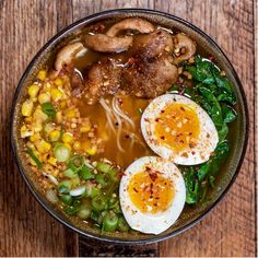 an overhead view of a bowl of soup with boiled eggs, vegetables and meats