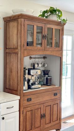 a wooden cabinet with glass doors in a kitchen