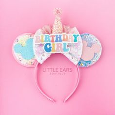 a minnie mouse ears headband with the words birthday girl on it and a pink background