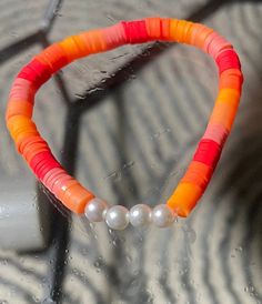 The Sunset Vibe clay bead bracelet, is an amazing bracelet for any type of clothing, and makes you feel so elegant, and beautiful especially with the 4 center pearl beads. Clay Bead Bracelet Color Combos Summer, Fruit Themed Clay Bead Bracelets, Colorful Clay Bead Bracelet, Sunset Clay Bead Bracelet, Clay Bracelets