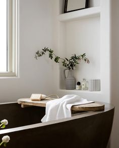 a bathtub with towels and flowers in it