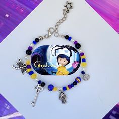 This elegant  Coraline-inspired Bracelet is perfect for anyone who loves the quirky and dark story.  The necklace made of  various glass beads pearl and crystal beads 💕 a black, blue, and yellow beads color with five different coraline charms on a delicate and strong high quality nylon cord.  It's the perfect addition to any outfit, Halloween costume and makes a great gift for any Coraline fan. - The bracelet length is: 6.5'' + 2'' extension. - Silver plated findings.  - Silver plated lobster c Coraline Bracelet Diy, Coraline Clay Bead Bracelet, Coraline Beaded Bracelet, Coraline Bracelet, Coraline Gifts, Coraline Inspired Jewelry, Halloween Costumes Glasses, Quirky Bracelets, Coraline Key Necklace