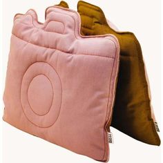 two pink and brown pillows sitting next to each other