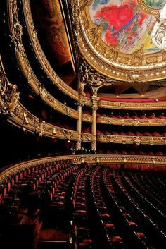 an ornately decorated auditorium with painted ceiling