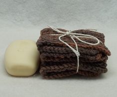 a soap bar sitting on top of a pile of brown crocheted cloths