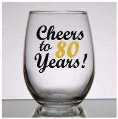 a wine glass that says cheers to 80 years