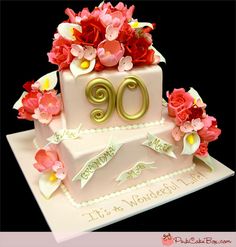 a birthday cake decorated with flowers and the number 90