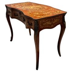 an old wooden table with floral designs on it's top and bottom edge, against a white background