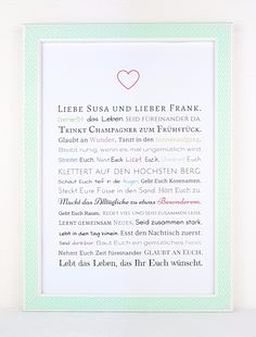 a white frame with a green border and a pink heart in the middle, on top of a shelf