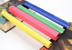 four different colored plastic tubes sitting on top of each other