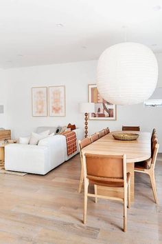 a living room filled with furniture and a large white ball hanging over the top of it