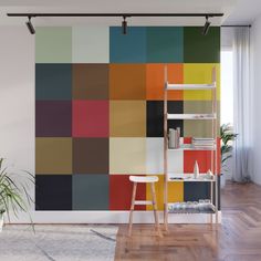 an abstract wall mural in a living room with wooden flooring and white walls, along with a ladder to the right