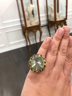 Such a glamorous ring to wear! With an alluring 53.50 carat moonstone in the center, surrounded by 7.8 carats of crystal blue aquamarine. All set in 18k yellow gold.  Size: 6 Weight: 40 grams