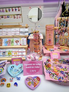 there are many items on the table for sale at this store, including bracelets and necklaces