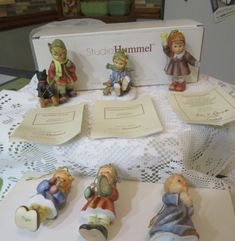 some figurines are sitting on a table next to a card board and box