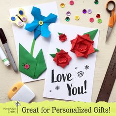 some paper flowers and scissors on a table with the words, love you great for personalized gifts