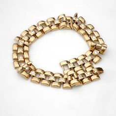 Wonderful and wide, this gold toned choker is 15.5 inches long and 3/4 of an inch wide. It closes securely with a fold over clasp. The style is kind of hybrid, maybe Egyptian revival meets Victorian. The central links are set with cut-glass stones that have little star burst pattern around them in the metal. The links are hollow formed so this piece is not too heavy to wear comfortably, weight is just about 2 ounces. Looks great layered with longer necklaces. Fine vintage condition with minor su Metal Link Chain Bracelet With Gold Clasp, Formal Metal Chain Choker, Gold Metal Chain Link Choker, Gold Chain Link Metal Choker, Metal Chain Link Jewelry With Gold Clasp, Gold Clasp Chain Link Jewelry, Gold Link Metal Choker, Retro Gold Chain Jewelry, Gold Retro Metal Bracelet