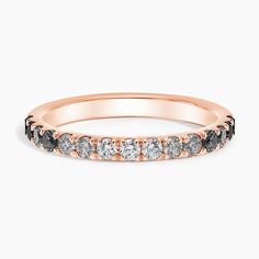 a rose gold wedding band with black and white diamonds on the side, set in 18k