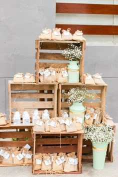 a stack of wooden crates filled with boxes and small white baby's breath flowers