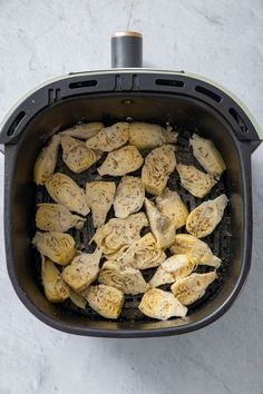 an overhead view of some peeled bananas in a pot