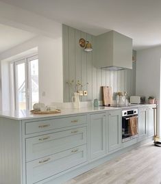 a kitchen with an oven, dishwasher and cabinets in white and grey colors