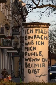 a large white sign on the side of a building with words written on it in german