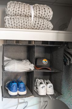 an organized closet with shoes and blankets