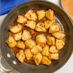 some food is cooking in a skillet on the stove and ready to be eaten