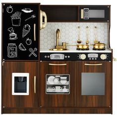 a wooden toy kitchen with black and white wall decals on the cabinets, including an oven