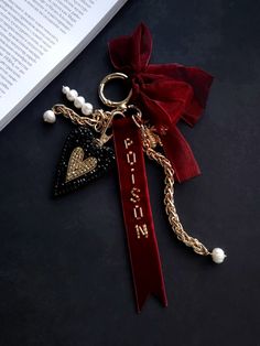 a red velvet keychain with an embroidered heart and the word love on it