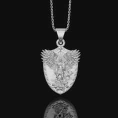 This intricately crafted Silver Archangel Micheal Pendant is a statement piece that everyone should have in their collection. It is made of pure, high quality sterling silver, delicately engraved with symbols of the angelic realm. Featuring an image of angelic figure of Archangel Micheal in mid-flight, this beautiful pendant is sure to evoke feelings of hope and protection. The pendant is suspended from a delicate silver chain, making it perfect for everyday wear. The Silver Archangel Micheal Pe St Michael Archangel, Michael Archangel, St Michael The Archangel, Divine Protection, Michael The Archangel, Angelic Realm, Chain Making, St Michael, Silver Pendants