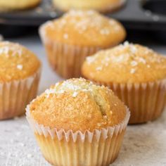 some muffins are sitting on a table with other muffins in the background