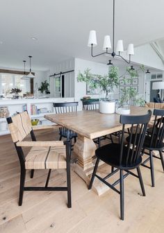 Coastal dining room with black chairs. Black windsor chairs and Serena & Lily Carson woven chairs complete this lake house dining area. Dining Table Black Chairs Wood Table, Windsor Dining Chairs Black, Black Chairs Light Wood Table, Rustic Table With Black Chairs, Rustic Table With Modern Chairs, Black Chairs And Wood Table, Dining Chairs Dark Wood Table, Dining Table Black And Wood, Black Table Light Chairs