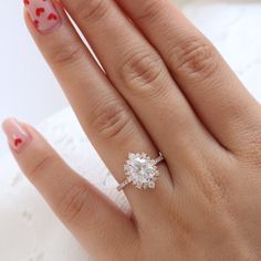 a woman's hand with a diamond ring on it