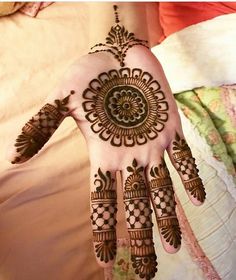 a woman's hand painted with hennap and intricate designs on her hands