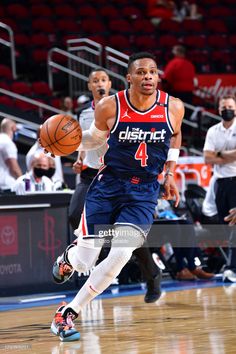 a basketball player dribbling the ball during a game