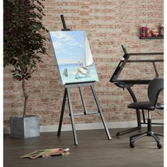 an easel and chair in front of a brick wall with a painting on it